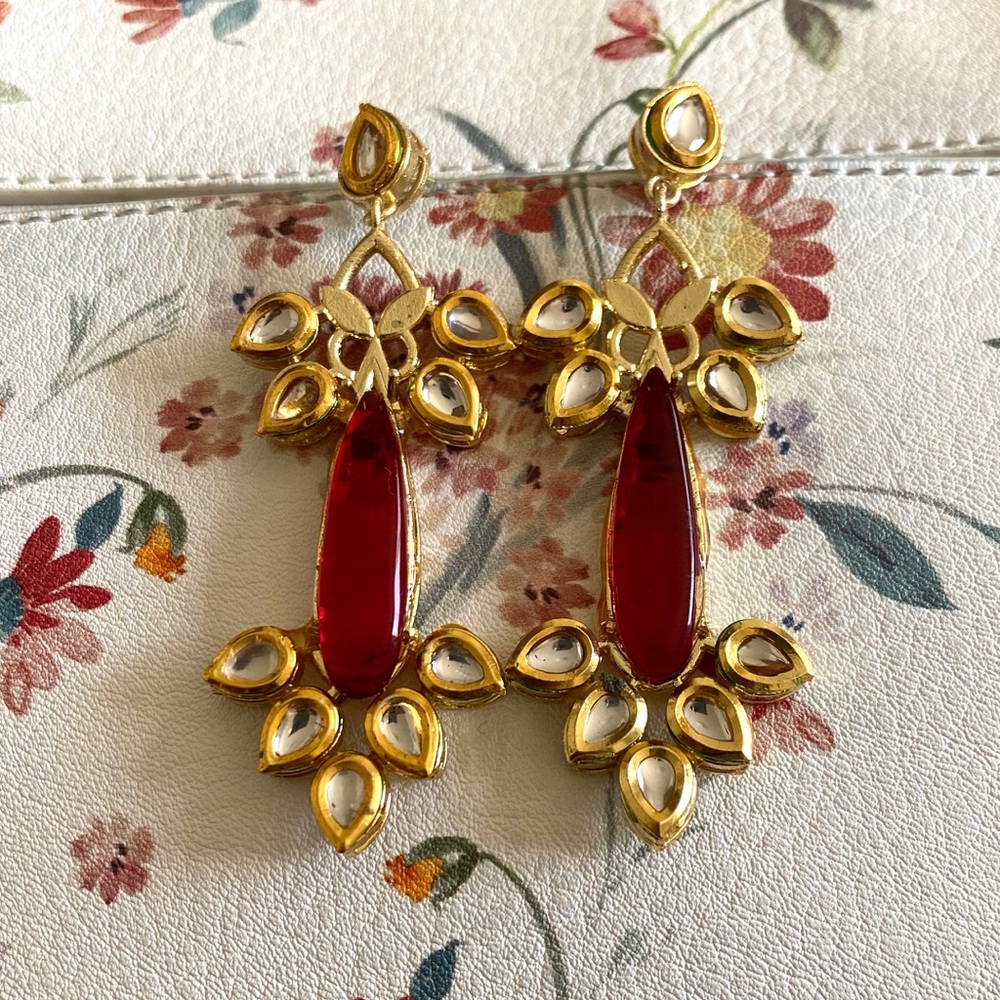 Red Kundan drop earrings.